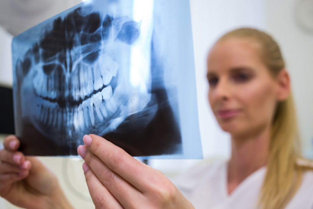 dentist-looking-dental-x-ray-plate.jpg